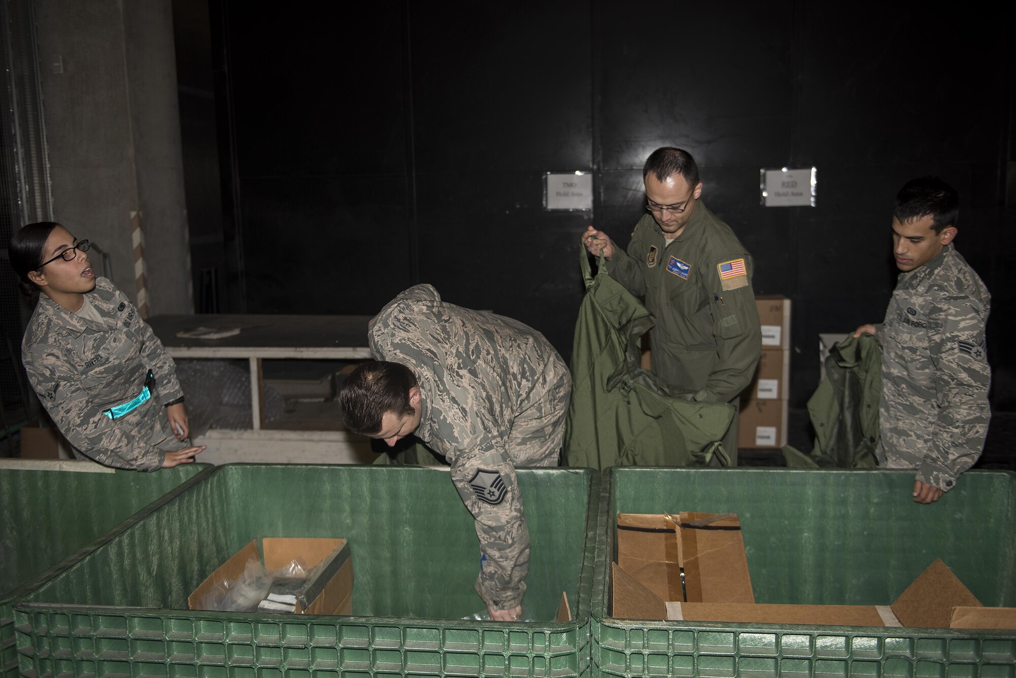 U.S. Air Force Airmen get Mission-Oriented Protective Posture gear during an exercise Feb. 7, 2017, at Kadena Air Base, Japan. The 18th Logistics Readiness Squadron practiced issuing real-world MOPP gear in order to perfect the process. (U.S. Air Force photo by Airman 1st Class Corey M. Pettis/Released)