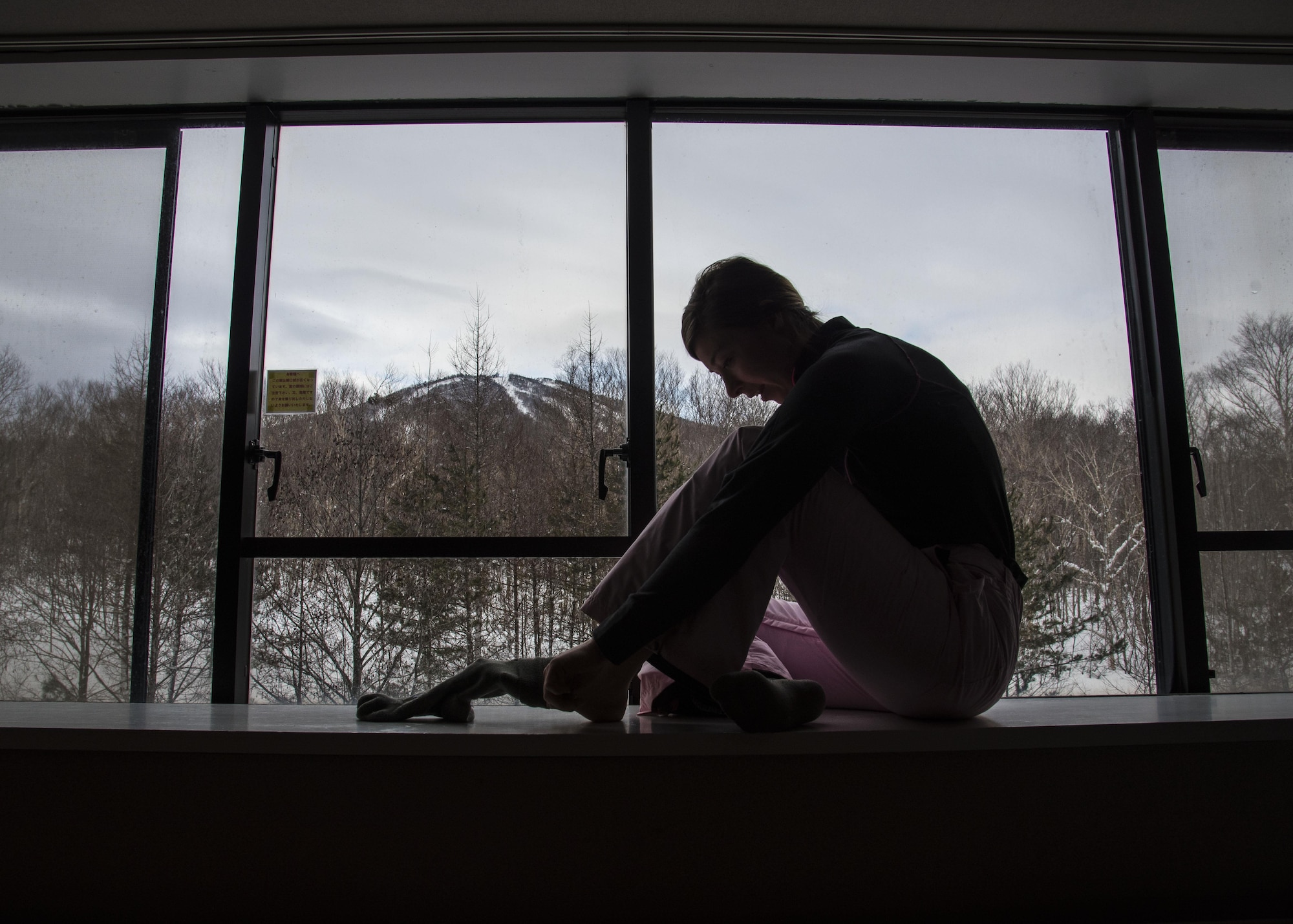 U.S. Air Force Airman 1st Class Katelin Napolitano, a 35th Medical Operations Squadron urgent care clinic technician, puts her snowboarding socks on at a ski resort at Hachimantai, Japan, Jan. 29, 2017. Approximately 40 Airmen from various shops participated in a resiliency retreat organized by Misawa's chaplain corps. (U.S. Air Force photo by Airman 1st Class Sadie Colbert)