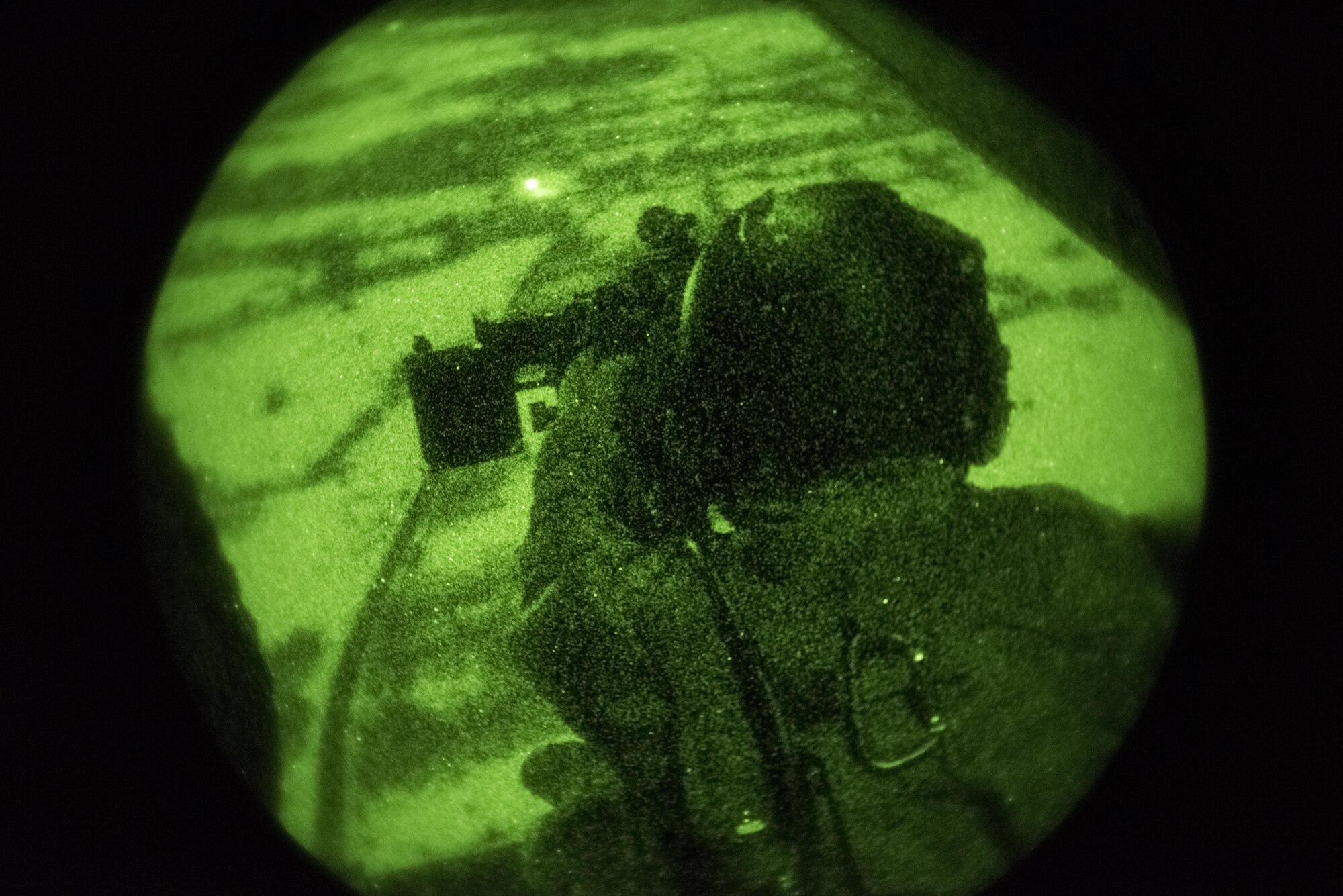 A U.S. special-mission aviator assigned to the 7th Special Operations Squadron mans a CV-22 Osprey ramp- mounted weapons system, a .50-caliber GAU-21 heavy machine gun, while traversing the air near Slunj Range, Croatia, Jan. 30, 2017. Slunj Range is part of the country’s Multi-national Aviation Training Complex, one of several MATC sites which provide 352d Special Operation Wing aircrews unique environments to achieve low-level flying, low-visibility landing, long-range infiltration/exfiltration and weapons system training objectives and develop tactics, techniques and procedures. (U.S. Air Force photo/1st Lt. Chris Sullivan)