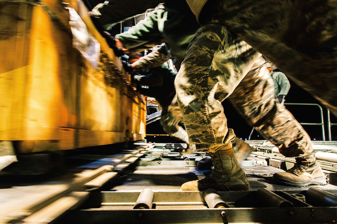 Airmen push a load of cargo into a C-130H Hercules aircraft at Qayyarah Airfield West, Iraq, Feb. 3, 2017. The airmen, assigned to the Montana’s Air National Guard’s 737th Expeditionary Airlift Squadron, delivered 30,000 pounds of cargo to support the military campaign against the Islamic State of Iraq and the Levant. Air Force photo by Senior Airman Jordan Castelan 