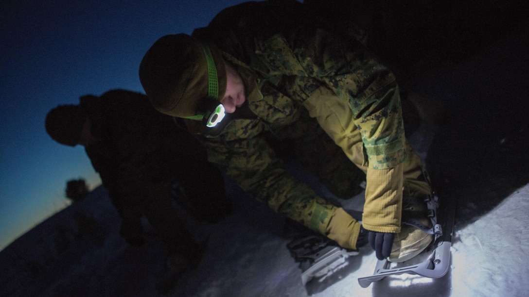 Lance Cpl. Emmitt Aimino, a rifleman with Company C, 1st Battalion, 25th Marine Regiment, 4th Marine Division, secures his snow shoes during exercise Riley Xanten II, in Burwash, Ontario, Feb. 3-5, 2017. During the exercise, the Marines joined soldiers from the Canadian Armed Forces to exchange knowledge and increase proficiency in cold weather tactics, survival skills, shelter building, ice fishing, and more. 