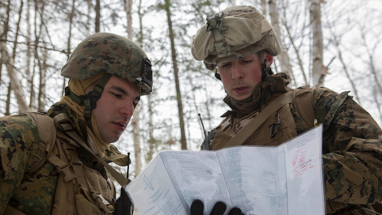Cpl. Tevfik Ozkaynak (left), a rifleman with Company C, 1st Battalion, 25th Marine Regiment, 4th Marine Division and Sgt. Lee Gugino (right), a squad leader, observe objective points on a map while on a reconnaissance patrol during exercise Riley Xanten II, in Burwash, Ontario, Feb. 3-5, 2017. During the exercise, the Marines joined soldiers from the Canadian Armed Forces to exchange knowledge and increase proficiency in cold weather tactics, survival skills, shelter building, ice fishing, and more.