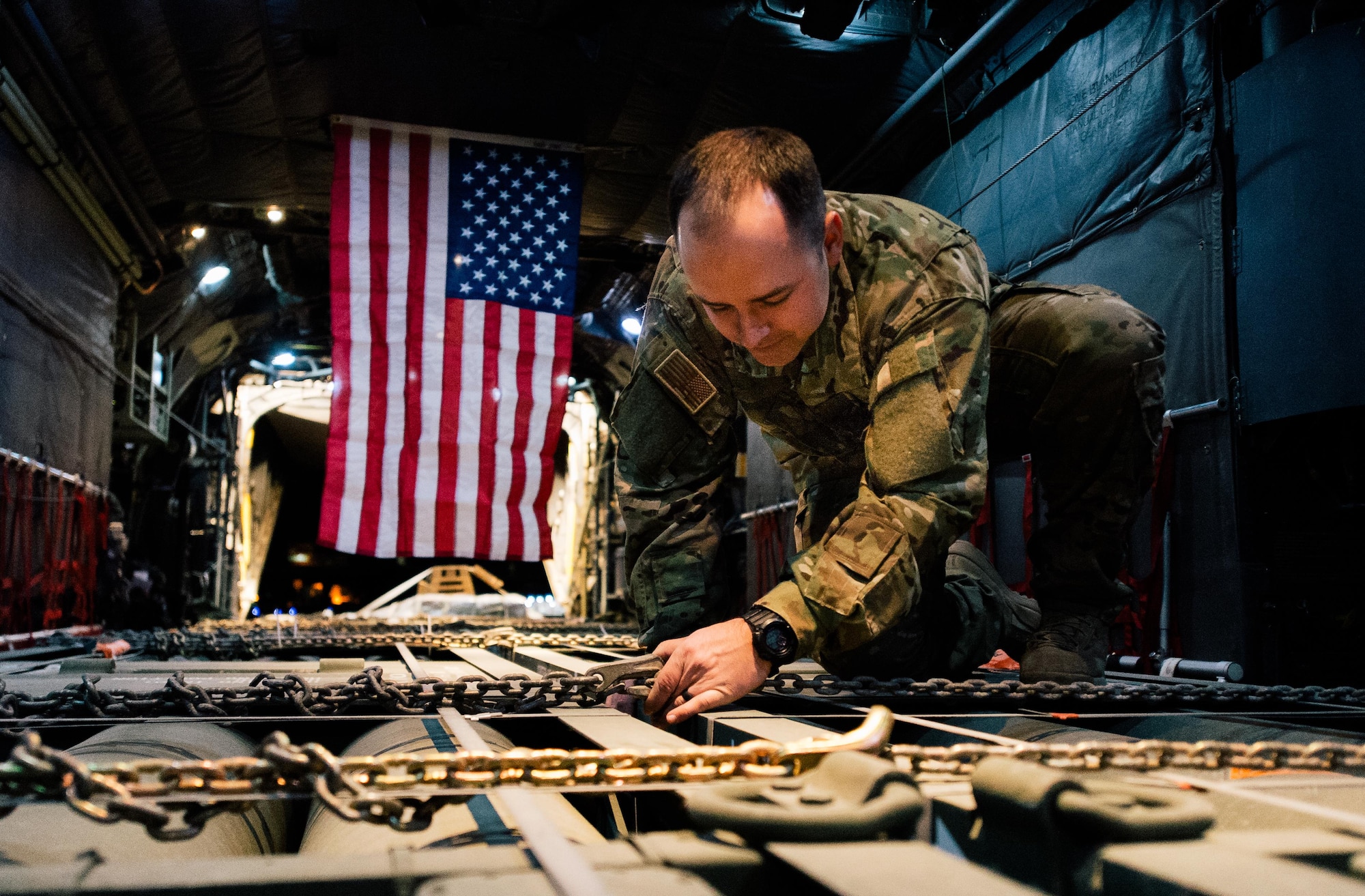 Senior Airman Creg Dubois, a 737th Expeditionary Airlift Squadron loadmaster, secures cargo before take-off inside a C-130H Hercules at an undisclosed location in Southwest Asia, Feb. 3, 2017. Dubois is part of a team that delivered 30,000 pounds of cargo to aide in the fight against ISIL. (U.S. Air Force photo/Senior Airman Jordan Castelan)