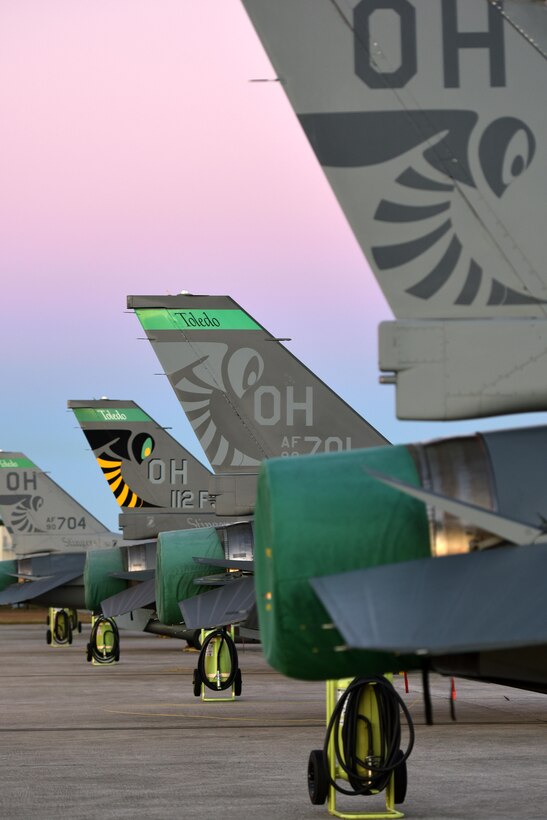 F-16 Fighting Falcons from the 180th Fighter Wing, Ohio Air National Guard, stand ready and waiting in the early morning hours, for the day’s training exercises to begin at MacDill Air Force Base in Tampa, Florida, Jan. 31, 2017. The 180th brought their F-16s, maintainers, pilots and operations specialists for a two-week long training exercise at MacDill, which included basic fight maneuvers against F-18 Hornets from the Canadian 425th Tactical Fighter Squadron. (Air National Guard photo by Tech. Sgt. Nic Kuetemeyer)