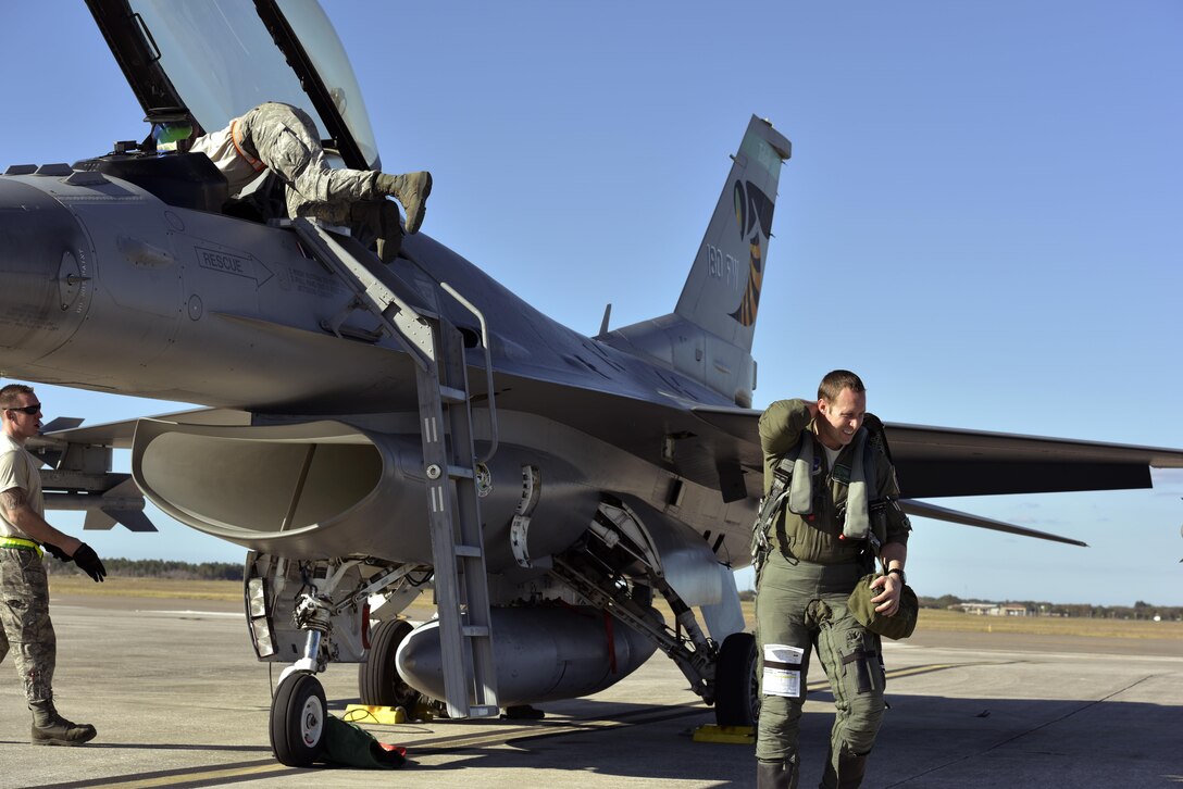 U.S. Air Force Captain Jerad Ames, F-16 pilot assigned to the 180th Fighter Wing, Ohio Air National Guard, exits a jet after his landing as crew chiefs start a process of checking the jet for mechanical issues and preparing for the next flight, known as recovery, at MacDill Air Force Base in Tampa, Florida, on Jan. 31, 2017. The 180th brought their F-16s, maintainers, pilots and operations specialists for a two-week  training exercise at MacDill, which included basic fight maneuvers against F-18 Hornets from the Canadian 425th Tactical Fighter Squadron. (Air National Guard photo by Tech. Sgt. Nic Kuetemeyer)