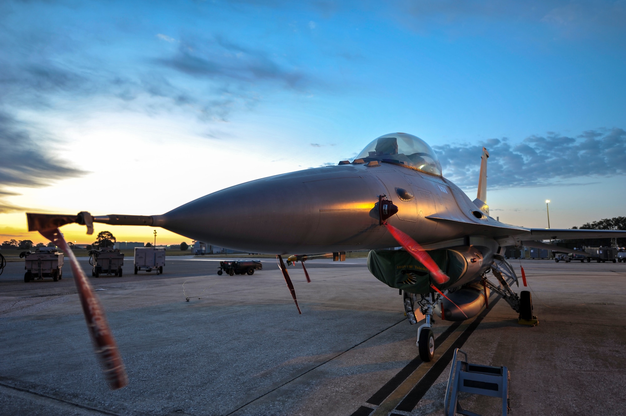 An F-16 Fighting Falcon from the 180th Fighter Wing in Swanton, Ohio stands ready and waiting in the early morning hours for the day’s training exercises to begin at MacDill Air Force Base in Tampa, Fla., on Feb. 2, 2017. The 180FW brought F-16s and more than 150 maintainers, pilots, and operations support personnel to MacDill for a two week training exercise which included basic fighter maneuvers against F-18 Hornets from the Canadian 425th Tactical Fighter Squadron, sharpening the combat capabilities of the 180FW Airmen. (U.S. Air National Guard photo by Tech. Sgt. Nic Kuetemeyer)