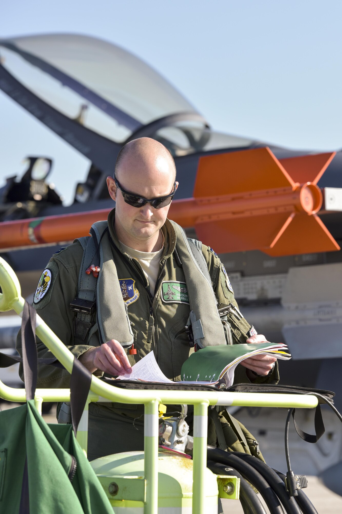 U.S. Air Force Capt. Seth Murray, a pilot assigned to the 180th Fighter Wing, Ohio Air National Guard, reviews critical information and maintenance notes about the F-16 Fighting Falcon during a training exercise at MacDill Air Force Base in Tampa, Florida on Feb. 2, 2017. The 180th brought F-16s and more than 150 maintainers, pilots, and operations support personnel to MacDill AFB for a two-week training exercise which included basic fighter maneuvers against F-18 Hornets from the Canadian 425th Tactical Fighter Squadron, sharpening the combat capabilities of 180FW Airmen. (U.S. Air National Guard photo by Tech. Sgt. Nic Kuetemeyer)