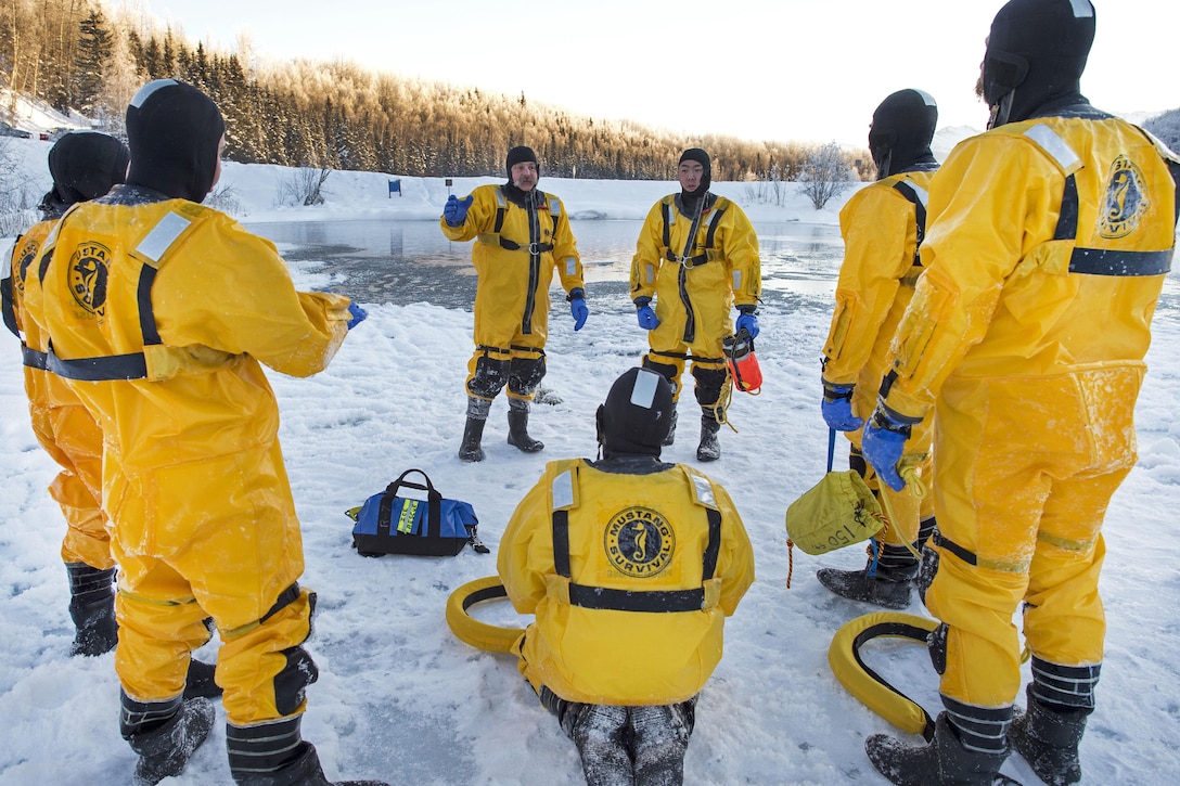 Kirk Gibbs, center, a fire captain, gives a safety briefing and instructs junior firefighters before participating in ice water rescue training at Joint Base Elmendorf-Richardson, Alaska, Feb. 4, 2017. Gibbs is assigned to the 673rd Civil Engineer Squadron. Air Force photo by Alejandro Pena    