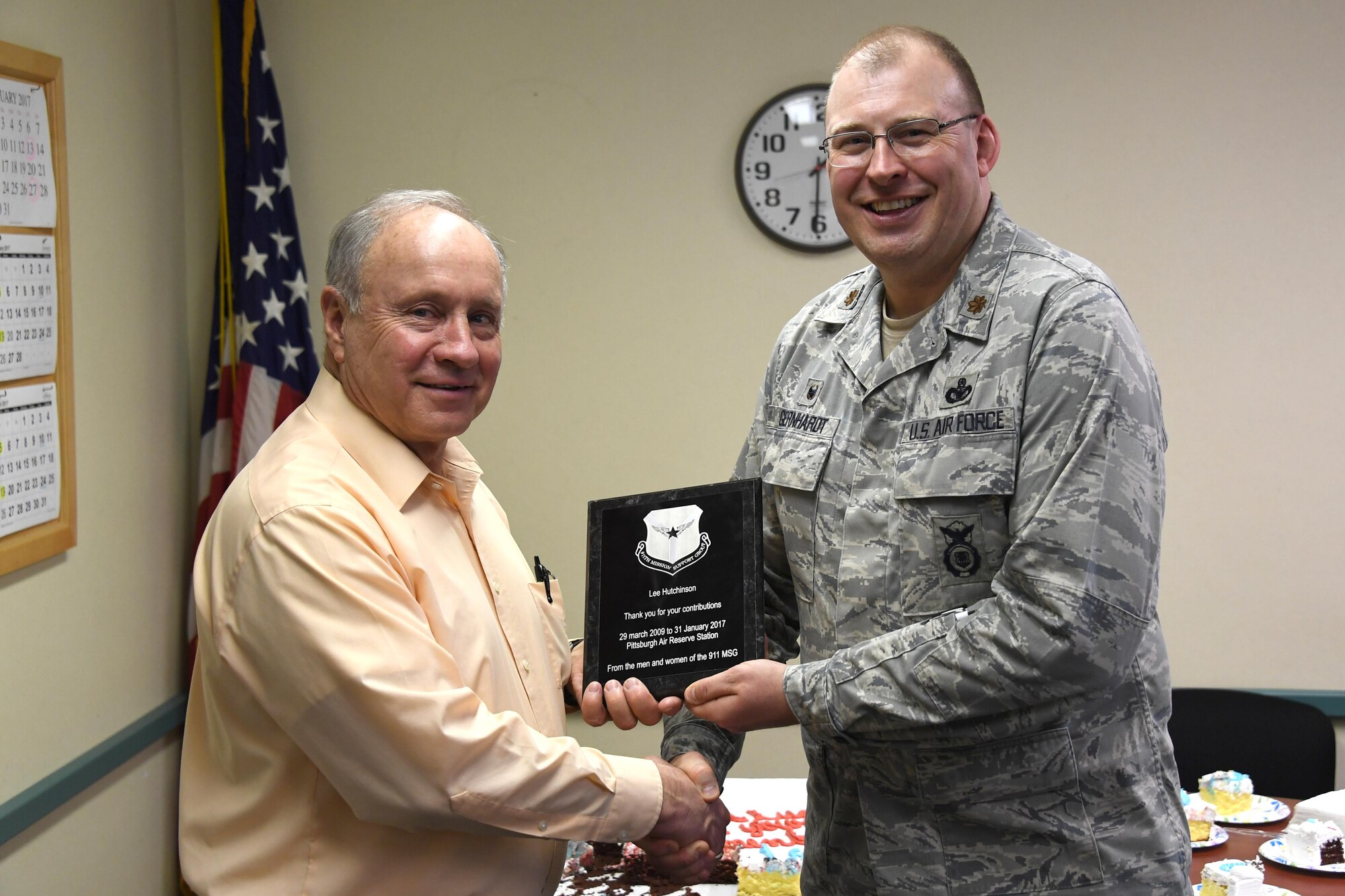 Lee Hutchison, former human resources manager with the 911th Mission Support Group, accepts a plaque from Maj. Randall Gernhardt in honor of his retirement at the Pittsburgh International Airport Air Reserve Station, Jan. 31, 2017. Hutchison served at the 911th MSG for almost eight years. (U.S. Air Force photo by Staff Sgt. Marjorie A. Bowlden)