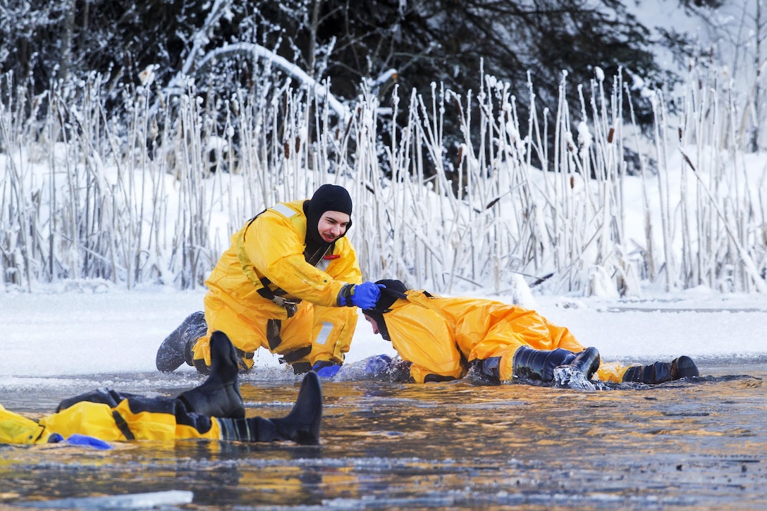 Air Force fire protection specialists Airmen 1st Class Tyler Parmelee, left, and Joseph Humphrey, practice victim recovery while conducting ice water rescue training at Joint Base Elmendorf-Richardson, Alaska, Feb. 4, 2017. Parmelee and Humphrey are assigned to the 673rd Civil Engineer Squadron. Air Force photo by Alejandro Pena