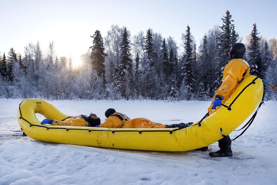 Air Force fire protection specialists use an inflatable raft to recover a simulated cold water victim while conducting ice water rescue training at Joint Base Elmendorf-Richardson, Alaska, Feb. 4, 2017. Air Force photo by Alejandro Pena