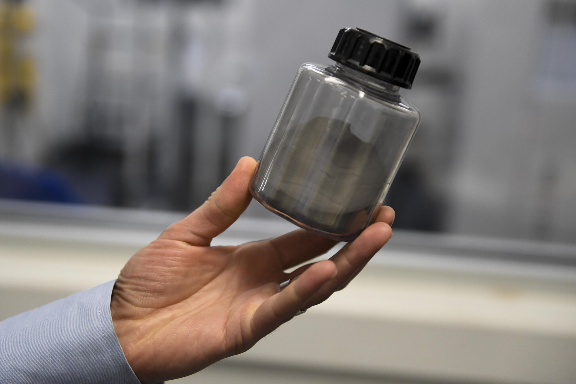 Kyle Cobb, NAWCAD Lakehurst Reverse Engineering Team-lead, displays a sample of titanium metal powder at Joint Base McGuire-Dix-Lakehurst, New Jersey, Feb. 8, 2017. The metallic powder is loaded into a 3-D printer which fuses the powder together to create the design of the engineers one layer at a time. 