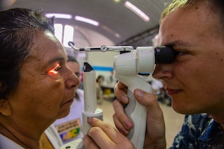 PUERTO BARRIOS, Guatemala (Feb. 4, 2017) -- Hospital Corpsman 3rd Class Brandon Morrison, a native of Tacoma, Wash., assigned to Naval Branch Health Clinic Belle Chasse, La., performs an eye exam on a host nation patient at the Continuing Promise 2017 (CP-17) medical site in Puerto Barrios, Guatemala. CP-17 is a U.S. Southern Command-sponsored and U.S. Naval Forces Southern Command/U.S. 4th Fleet-conducted deployment to conduct civil-military operations including humanitarian assistance, training engagements, and medical, dental, and veterinary support in an effort to show U.S. support and commitment to Central and South America. (U.S. Navy Combat Camera photo by Petty Officer 2nd Class Brittney Cannady)