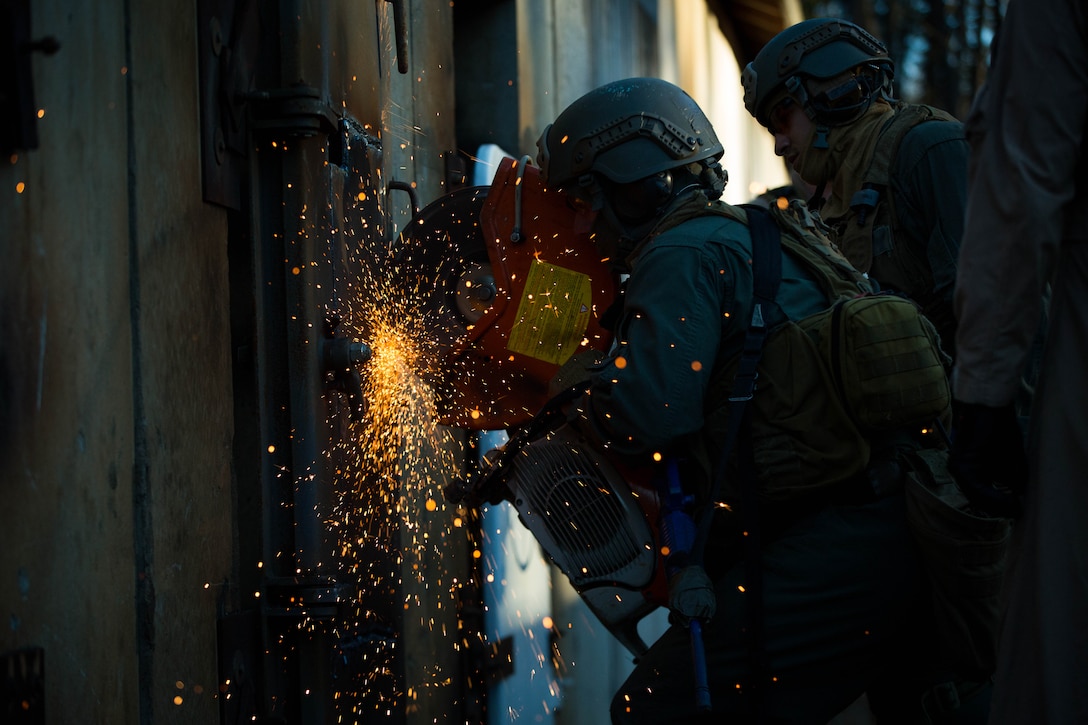 U.S. Marines attending the Methods of Entry (MOE) course, use a saw to cut through steel during a practical application exercise at Marine Corps Base Quantico, Virginia, Jan. 25, 2017. MOE teaches Marines advanced level skills on how to properly and effectively gain entry into buildings, structures and ships.