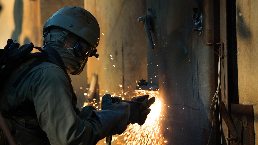 A U.S. Marine attending the Methods of Entry (MOE) course, uses a torch to cut through steel during a practical application exercise at Marine Corps Base Quantico Virginia, Jan. 25, 2017. MOE teaches Marines advanced level skills on how to properly and effectively gain entry into buildings, structures and ships. 