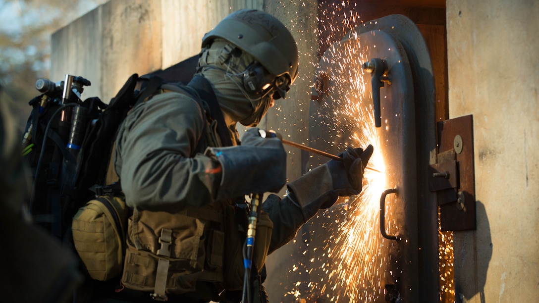 A U.S. Marine attending the Methods of Entry (MOE) course, uses a torch to cut through steel during a practical application exercise at Marine Corps Base Quantico, Virginia, Jan. 25, 2017. MOE teaches Marines advanced level skills on how to properly and effectively gain entry into buildings, structures and ships. 