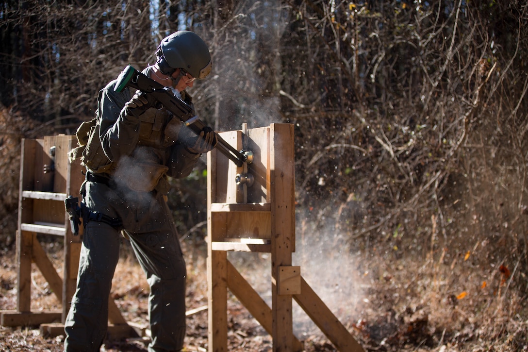 A U.S. Marine attending the Methods of Entry (MOE) course, fires an M1014 shotgun at a simulated lock during a practical application exercise at Marine Corps Base Quantico, Virginia, Jan. 25, 2017. MOE teaches Marines advanced level skills on how to properly and effectively gain entry into buildings, structures and ships. 