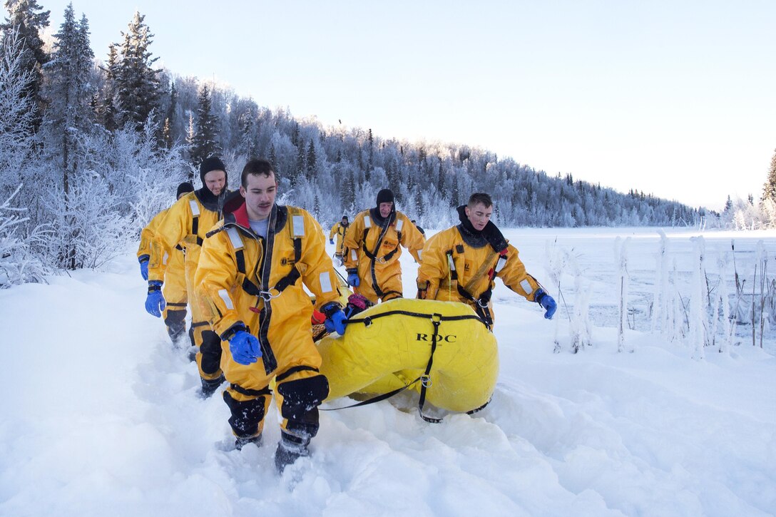 Air Force fire protection specialists leave a frozen lake after conducting ice water rescue training at Joint Base Elmendorf-Richardson, Alaska, Feb. 4, 2017. Air Force photo by Alejandro Pena