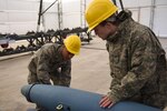U.S. Air Force Airman 1st Class Jeremiah L. Buckmaster and Airman 1st Class Joshua E. Holland, munitions systems specialists assigned to the 180th Fighter Wing, Ohio Air National Guard, inspect inert Mark 82 bomb bodies Feb. 5, 2017, at the Toledo Express Airport in Swanton, Ohio. Munitions systems specialists procure, inspect, store, recondition, issue, transport, maintain, test and assemble GPS/laser guided and unguided munitions for 180FW F-16 Fighting Falcons. 