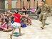 Capt. Robert Orallo, 26th Aerial Port Squadron ramp flight commander, surprises his daughter Iliana during story-time Feb. 7, 2017 at Bulverde Creek Elementary School. Orallo, who recently returned from a six month deployment to Iraq, surprised his daughter in the school cafeteria as her class read a fairy tale story that was written by Capt. Orallo during his deployment.  (U.S.  Air Force photo by Benjamin Faske)
