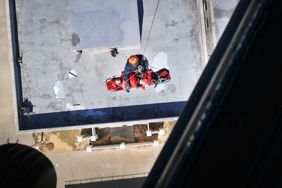 Army National Guard soldiers, fire department and emergency medical services rescuers from the South Carolina Helicopter Aquatic Rescue Team, and the South Carolina Urban Search and Rescue Task Force 1, participate in hoist training during Patriot South Exercise 2017, at the Gulfport and Port Bienville Industrial Complex, Mississippi, Jan. 31, 2017. Army National Guard photo by Staff Sgt. Roberto Di Giovine