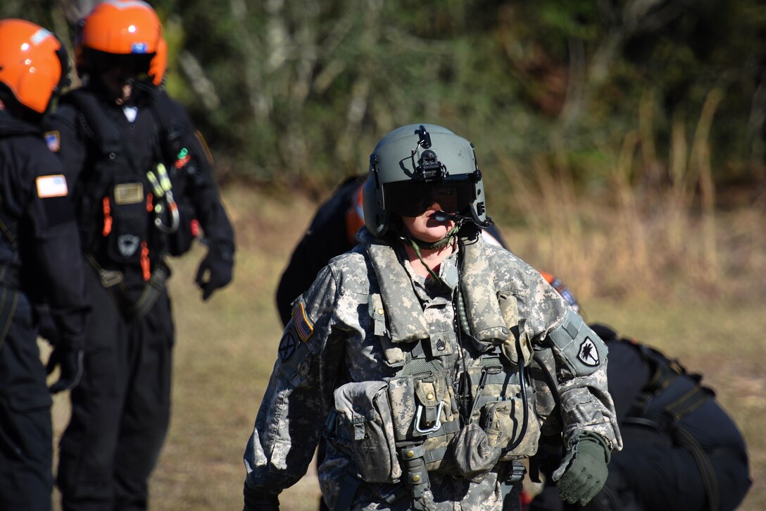 Army National Guard soldiers, fire department and emergency medical services rescuers from the South Carolina Helicopter Aquatic Rescue Team, and the South Carolina Urban Search and Rescue Task Force 1, prepare their equipment before participating in hoist training during Patriot South Exercise 2017, at the Gulfport and Port Bienville Industrial Complex, Mississippi, Jan. 31, 2017. The soldiers are assigned to the South Carolina Army National Guard’s Headquarters Company, Company A, 2nd Battalion, 151st Security and Support Aviation Battalion, and 59th Aviation Troop Command. The joint training focuses on natural disaster response, preparedness and an opportunity to test response capabilities, procedures, and readiness through a simulated earthquake and tsunami scenario hitting the coastal areas of the state. Army National Guard photo by Staff Sgt. Roberto Di Giovine