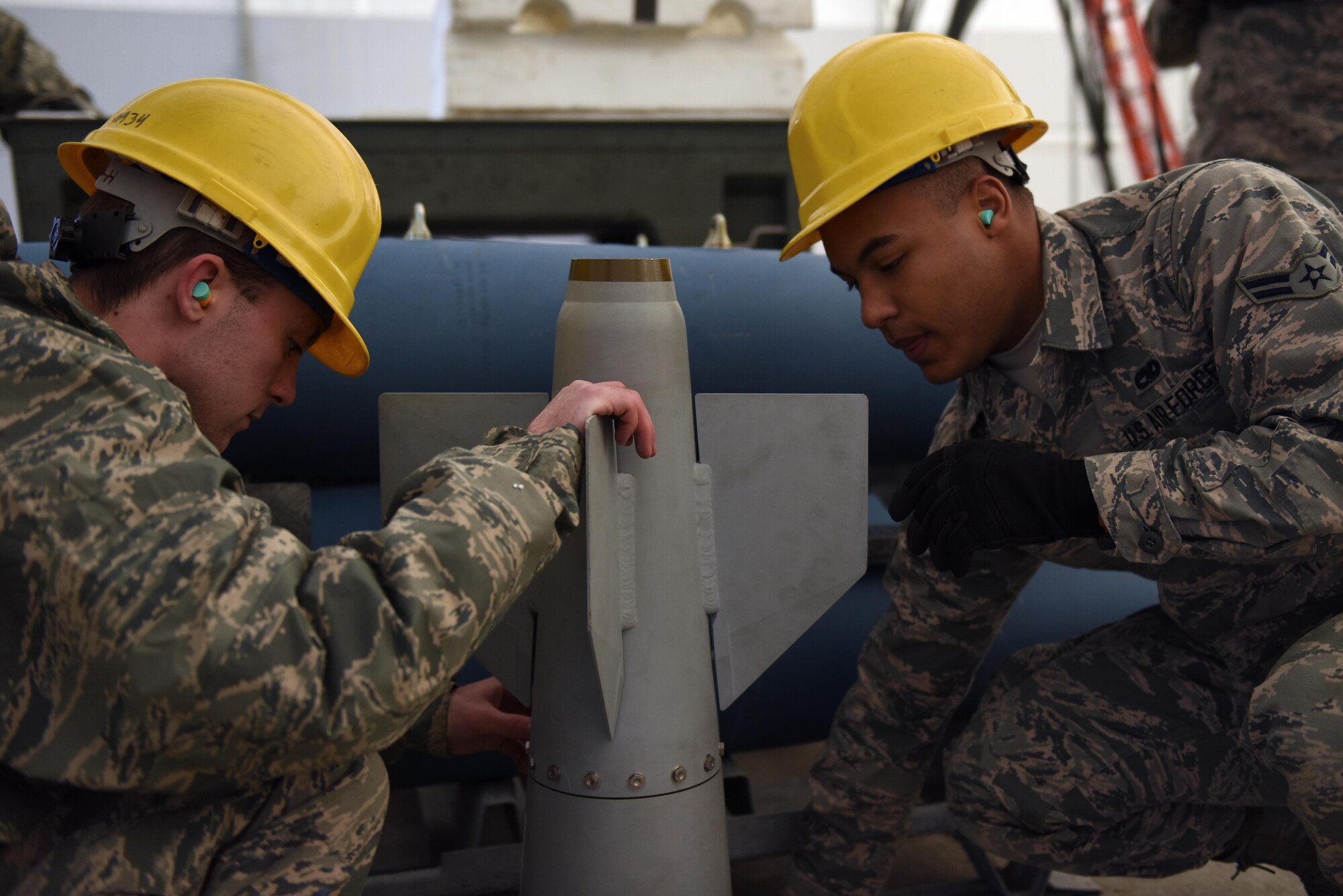 U.S. Air Force Airman 1st Class Joshua E. Holland and Airman 1st Class Jeremiah L. Buckmaster, munitions systems specialists assigned to the 180th Fighter Wing, Ohio Air National Guard, inspect a GPS guided airfoil group Feb. 5, 2017 at the Toledo Express Airport in Swanton, Ohio. Munitions systems specialists procure, inspect, store, recondition, issue, transport, maintain, test and assemble GPS/laser guided and unguided munitions for 180FW F-16 Fighting Falcons. (U.S. Air National Guard photo by Staff Sgt. John Wilkes)