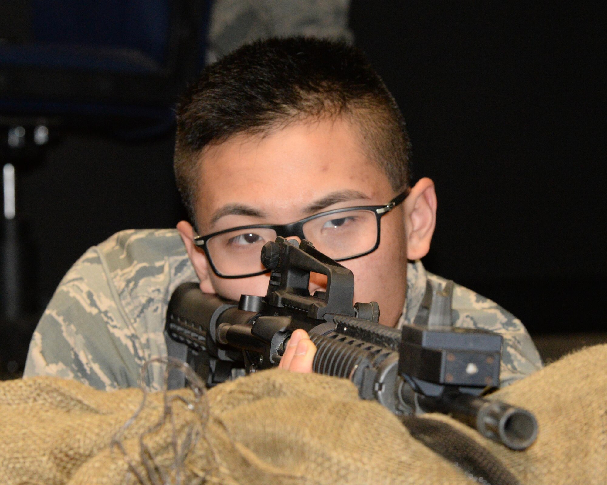 U.S. Air Force Airman 1st Class Hoang Nguyen, New Hampshire Air National Guard Student flight trainee, fires an M-4 rifle in the Firearms Training Simulator at the New Hampshire Army National Guard’s Training Site, Center Strafford, N.H., Feb. 4, 2017.  The weapons familiarization prepares Airmen for basic training. (U.S. Air National Guard photo by Staff Sgt. Curtis J. Lenz)