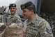 Airman First Class Travis Roemmele, passes equipment to Technical Sergeant Joshua Ramirez, 108th Security Forces Members bucket line style out of a storage unit at the 108th Wing, Joint Base McGuire-Dix-Lakehurst, N.J., Jan. 17, 2017. The 108th Security Forces are preparing to support Local Emergency Services in Washington D. C. during the 58th Presidential Inauguration. (U.S. Air National Guard photo by Staff Sgt. Ross A. Whitley/Released)