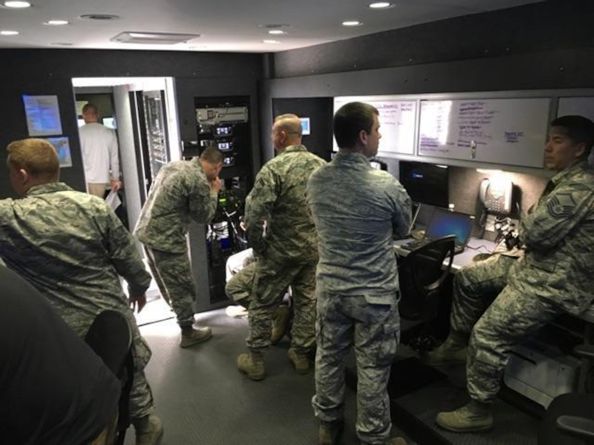 The North Carolina Air National Guard Mobile Emergency Operations Center (MEOC) team works diligently to provide backup communications to three tactical operations centers Task Force Security, Task Force Crowd, and Task Force Access, in Washington D.C., Jan. 19, 2017. The team consists of National Guard Airmen Master Sg.t Rebecca Tongen, Staff Sgt. Mark Fow, Senior Master Sgt. James Cutshaw, Master Sgt. Timothy Jones, Staff Sergeant Benjamin Elliot, Brigadier Gen. Staudenraus, and Master Sgt. Erik Kennedy. About 8000 soldiers and airmen are tasked to support the 58th United States presidential inauguration on Jan. 20, 2017. (U.S. Air National Guard photo credited to Master Sgt. Rebecca S. Tongen)