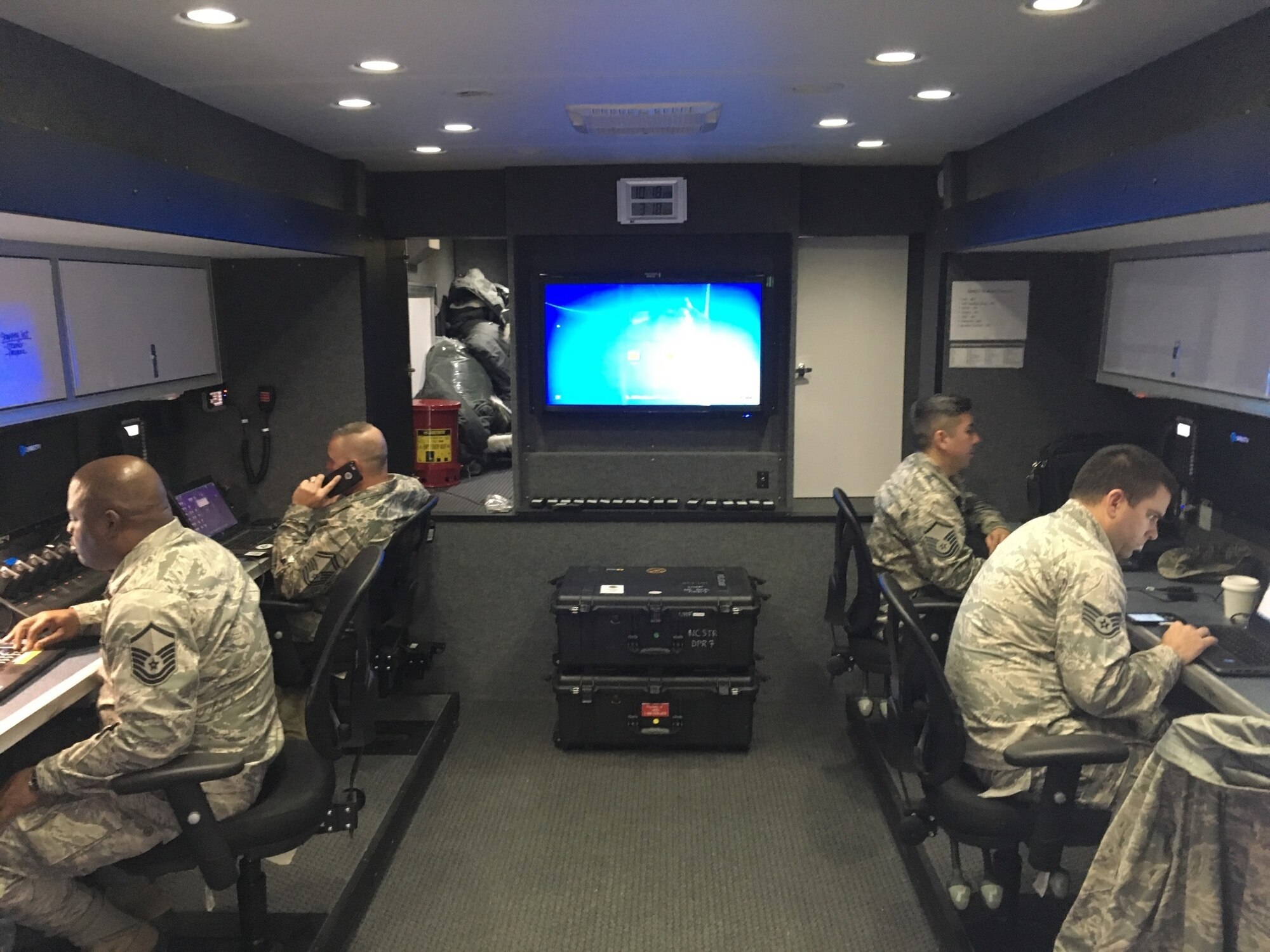 The North Carolina Air National Guard Mobile Emergency Operations Center (MEOC) team works diligently to provide backup communications to three tactical operations centers Task Force Security, Task Force Crowd, and Task Force Access, in Washington D.C., Jan. 19, 2017. The team consists of National Guard Airmen Master Sg.t Rebecca Tongen, Staff Sgt. Mark Fow, Senior Master Sgt. James Cutshaw, Master Sgt. Timothy Jones, Staff Sergeant Benjamin Elliot, Brigadier Gen. Staudenraus, and Master Sgt. Erik Kennedy. About 8000 soldiers and airmen are tasked to support the 58th United States presidential inauguration on Jan. 20, 2017. (U.S. Air National Guard photo credited to Master Sgt. Rebecca S. Tongen)