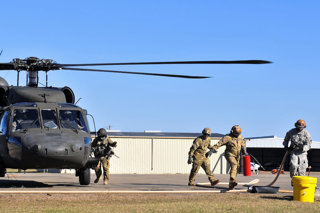 Army National Guardsmen refuel a UH-60 Black Hawk helicopter after participating in the Patriot South Exercise 2017 at the Gulfport and Port Bienville Industrial Complex, Mississippi, Jan. 31, 2017. Army National Guard photo by Staff Sgt. Roberto Di Giovine
