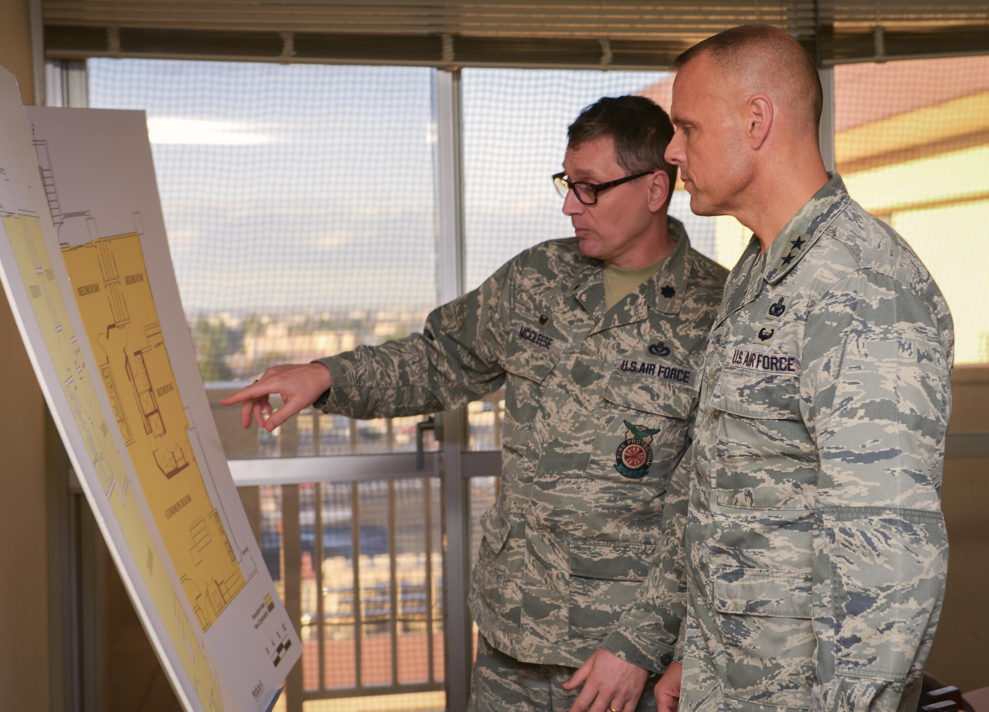 Lt. Col. David Mccleese, 374th Civil Engineer Squadron commander, briefs Maj. Gen. Bradley Spacy, Air Force Installation and Mission Support Center commander, on theoretical housing arrangements for Airmen at Yokota Air Base, Japan, Jan. 30, 2017. Spacy visited three Pacific Air Forces bases to see the installation and mission support  operations across the board. (U.S. Air Force photo by Senior Airman Elizabeth Baker)