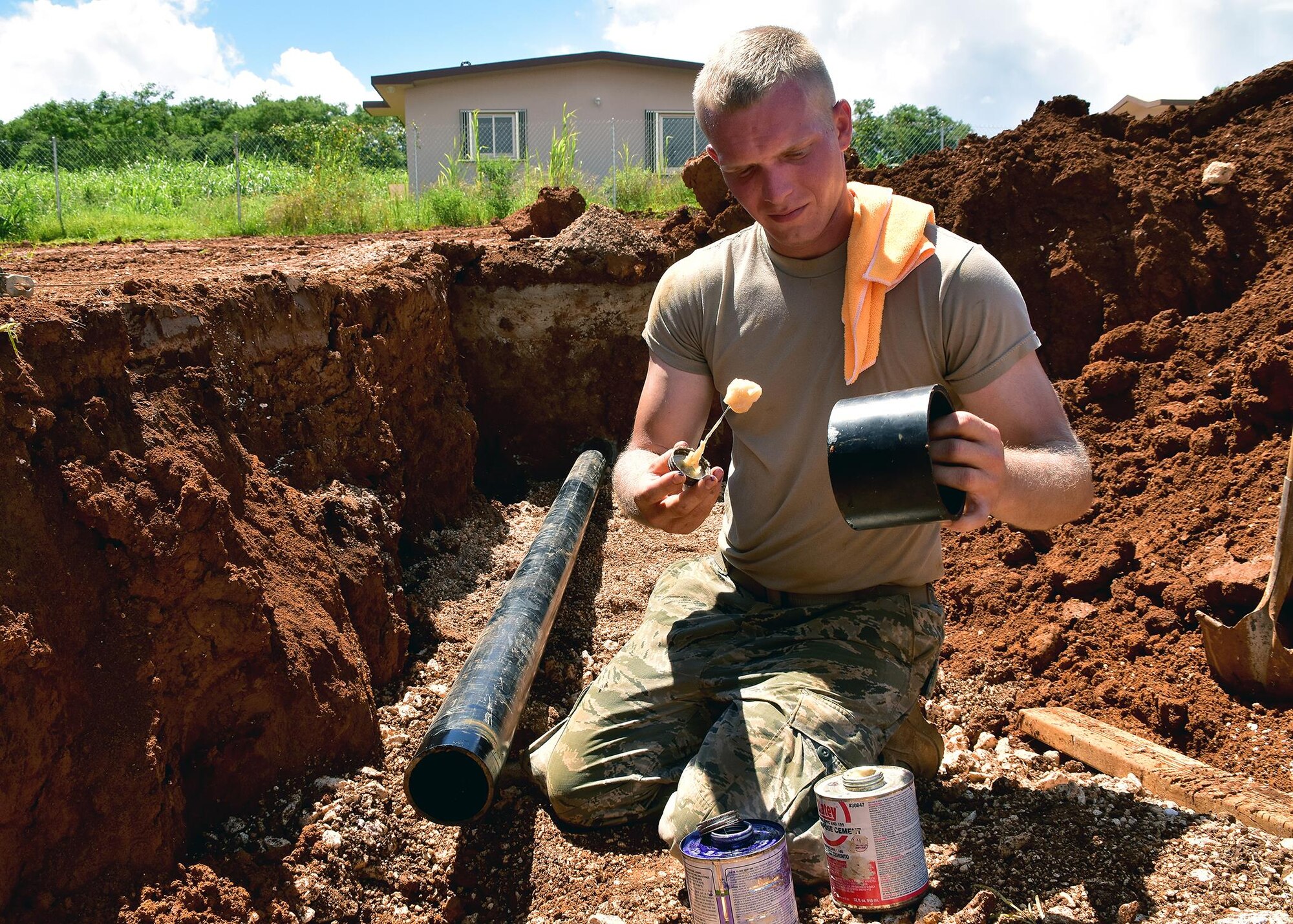 Senior Airman Daniel Kirwin from the 143d Civil Engineering Squadron (CES), Rhode Island Air National Guard glues PVC cement to a coupling for sewer system in Inarajan, Guam during an Innovative Readiness Training (IRT) project on September 6, 2016.  The IRT project, in conjunction with Habitat for Humanity Guam is to provide two homes for residents in Inarajan.  The members are part of a 36 Airmen crew from a cross section of trades within the CES.  U.S. Air National Guard photo by Master Sgt. John V. McDonald