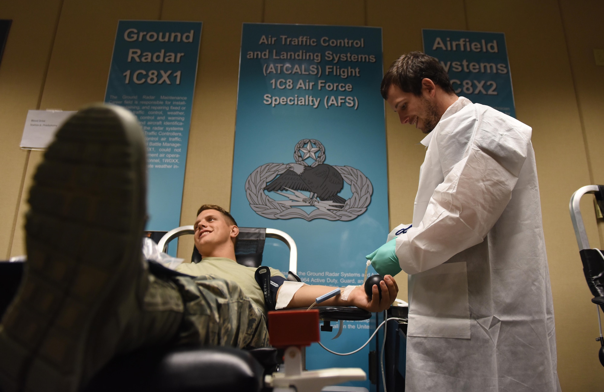 Taylor Neitman, 81st Diagnostic and Therapeutics Squadron medical laboratory technician, draws blood from Airman 1st Class Tré Moritz, 336th Training Squadron student, during a blood drive at Cody Hall Nov. 21, 2016, on Keesler Air Force Base, Miss. The Keesler Blood Donor Center is one of three Air Force blood donor centers and supports the Armed Services Blood Program by collecting blood for the Defense Department for use in deployed locations and military treatment facilities. (U.S. Air Force photo by Senior Airman Holly Mansfield)  