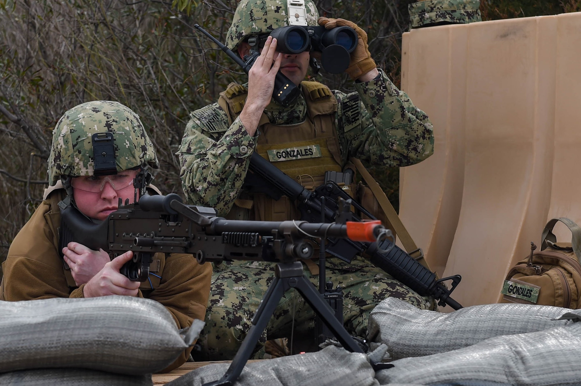 U.S. Coast Guard Maritime Enforcement Specialist 2nd Class Nicholas Polino, Port Security Unit 305 Shoreside Division fire team member, and Maritime Enforcement Specialist 3rd Class Jerry Gonzales, PSU 305 Shoreside Division fire team leader, keep watch in a battle position during a deployment exercise at Joint Base Langley-Eustis, Va., Feb. 2, 2017. The members in battle positions were stationed on the shore as the last line of defense in the event of an unauthorized approach. (U.S. Air Force photo by Airman 1st Class Derek Seifert)