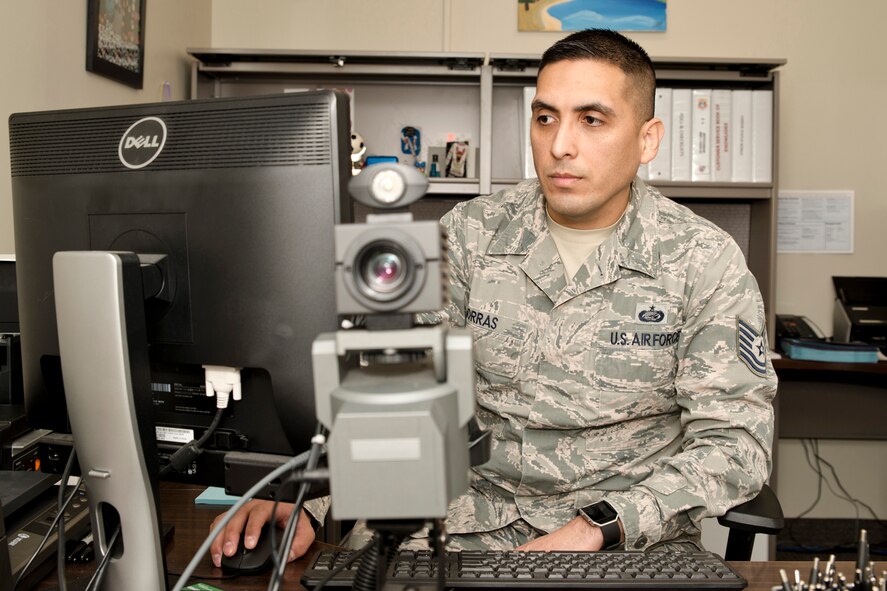 U.S. Air Force Reserve Tech. Sgt. Robert Porras, customer service supervisor, 913th Force Support Squadron, boots up the program to issue identification cards Feb. 7, 2017, at little Rock Air Force Base, Ark. Using the Defense Enrollment Eligibility Reporting System, (DEERS) Porras helps members enroll in benefit programs and produces identification cards that allow access to military bases worldwide. (U.S. Air Force photo by Master Sgt. Jeff Walston/Released)