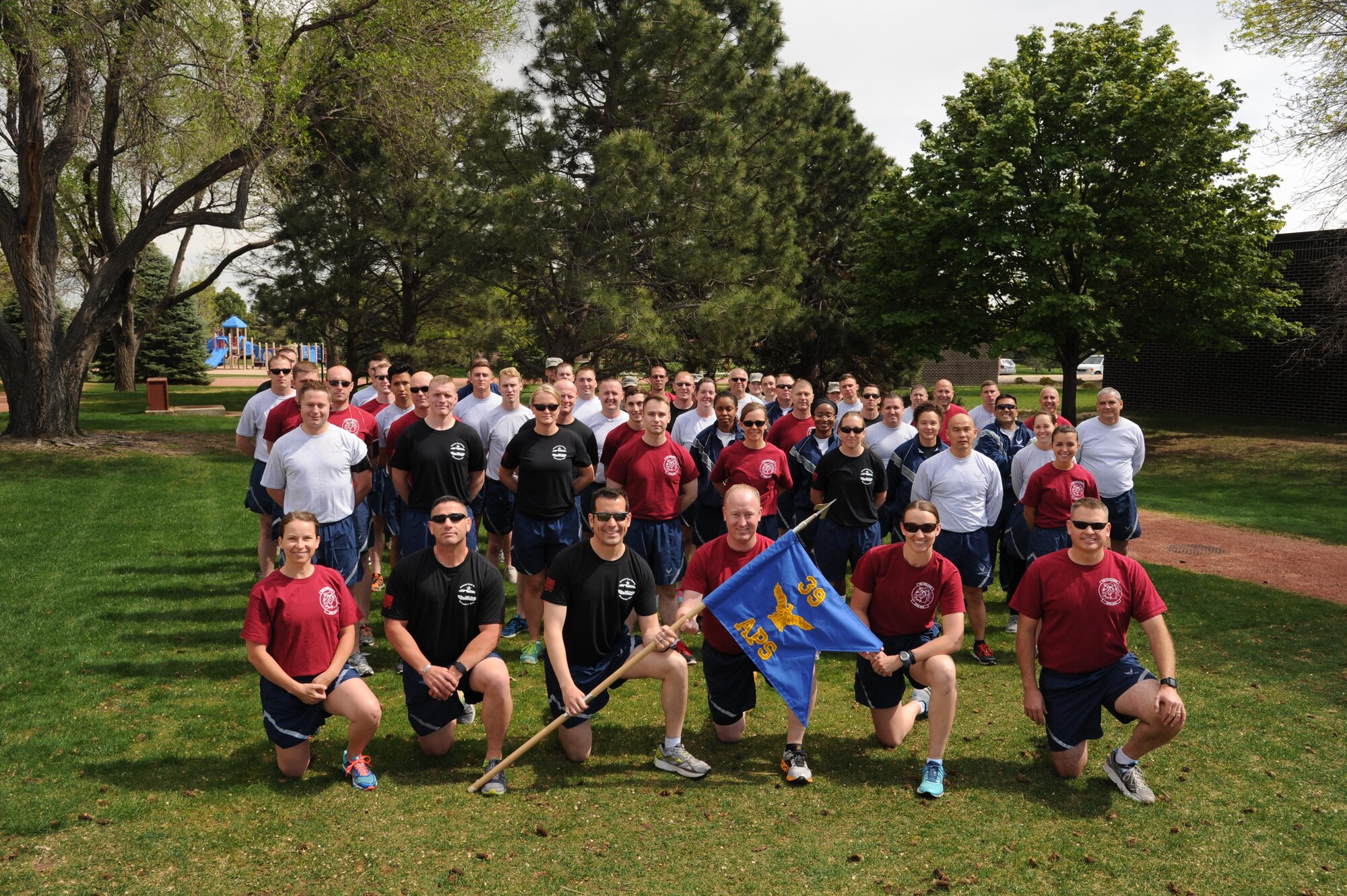 Members of the 39th Aerial Port Squadron pose with their guideon before running the annual Port Dawg Memorial Run, May 14, 2016 here. More than 30 of the squadron members are deployed, or getting ready to deploy, to Southwest Asia for six months. (U.S. Air Force photo/Staff Sgt. Amber Sorsek)