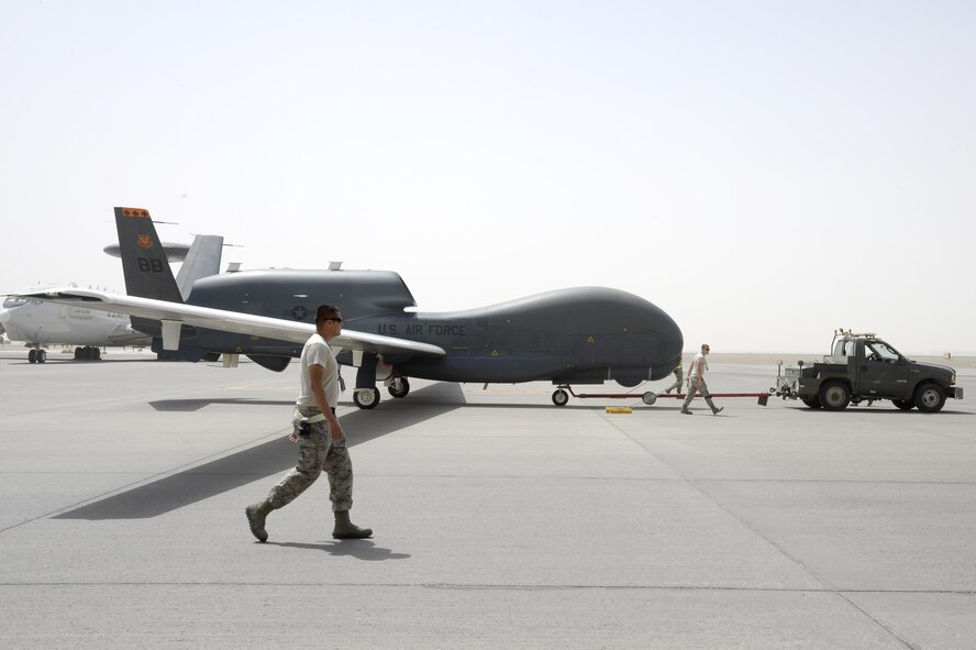 Airmen from an RQ-4B Global Hawk aircraft maintenance unit welcome an RQ-4B after a flight in 2015, in Southwest Asia, in which the aircraft surpassed 10,000 flying hours. When outfitted with communications capabilities, like the Battlefield Airborne Communications Node, a fleet of three redesignated EQ-4B Global Hawks provide clear, precise and reliable communication for Joint and Coalition partners in the Central Command Area of Responsibility. (U.S. Air Force photo/Tech. Sgt. Marie Brown)
