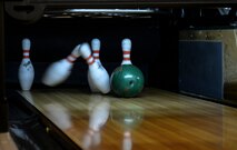 A bowling ball knocks over pins during a “Chiefs vs. Eagles” game Feb. 7, 2017, on RAF Mildenhall, England. Team Mildenhall leaders take part in quarterly events to build camaraderie amongst the chief master sergeants and colonels. (U.S. Air Force photo by Staff Sgt. Micaiah Anthony)