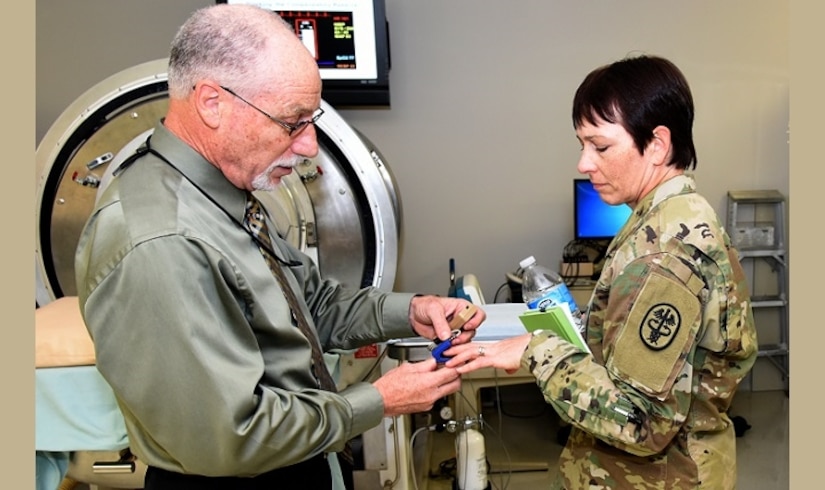 U.S. Army Institute of Surgical Research senior scientist Dr. Victor Convertino, right, demonstrates the functions and capabilities of the Compensatory Reserve Index to Army Maj. Gen. Barbara Holcomb, commanding general, U.S. Army Medical Research and Material Command. Army photo by Steven Galvan