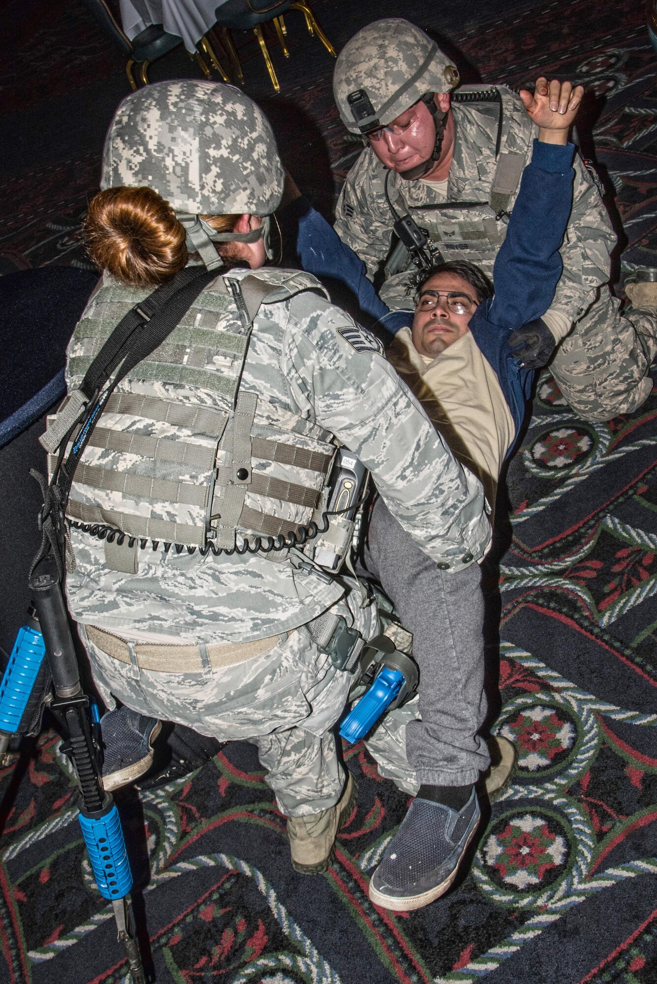 The 375th Security Forces Squadron work with the 375th Medical Group for an active shoort exercise. Medical group teams applied moulage to "victims" before the exercise started and placed them around the Scott Event Center before the exercise started. The exercise helped security forces personnel identify any short falls or limiting factors in respone capabilities and gave them a chance to test and train new tactics and procedues. It also afforded security forces the opportunity to train with the other first responders (fire department and medical) to ensure they can work cohesivley to neutralize the threat, secure the scene and treat victims and casualties as soon as possible. The overall goal is to be prepared to respond efficienty and effectively to minimize the loss of life in the event of an active shooter.(U.S. Air Force photos/Senior Airman Tristin English)