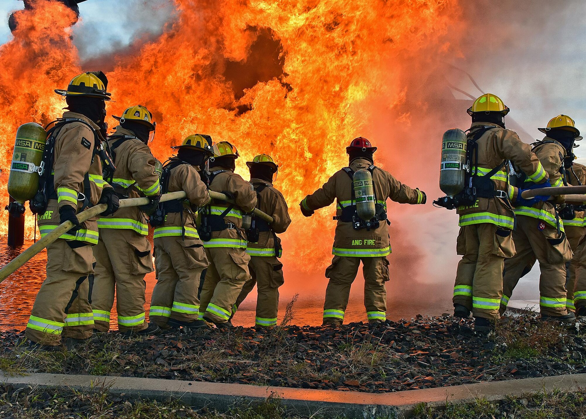 Military and Civilian members of the Quonset Fire Department from the 143d Airlift Wing, Rhode Island Air National Guard conduct live fire training at Westover Air Reserve Base, Chicopee, Massachusetts, September 29, 2016. The live fire training is part of annual qualification requirements and allows military and civilians to train in collaboration. US Air National Guard Photo by Master Sgt Janeen Miller