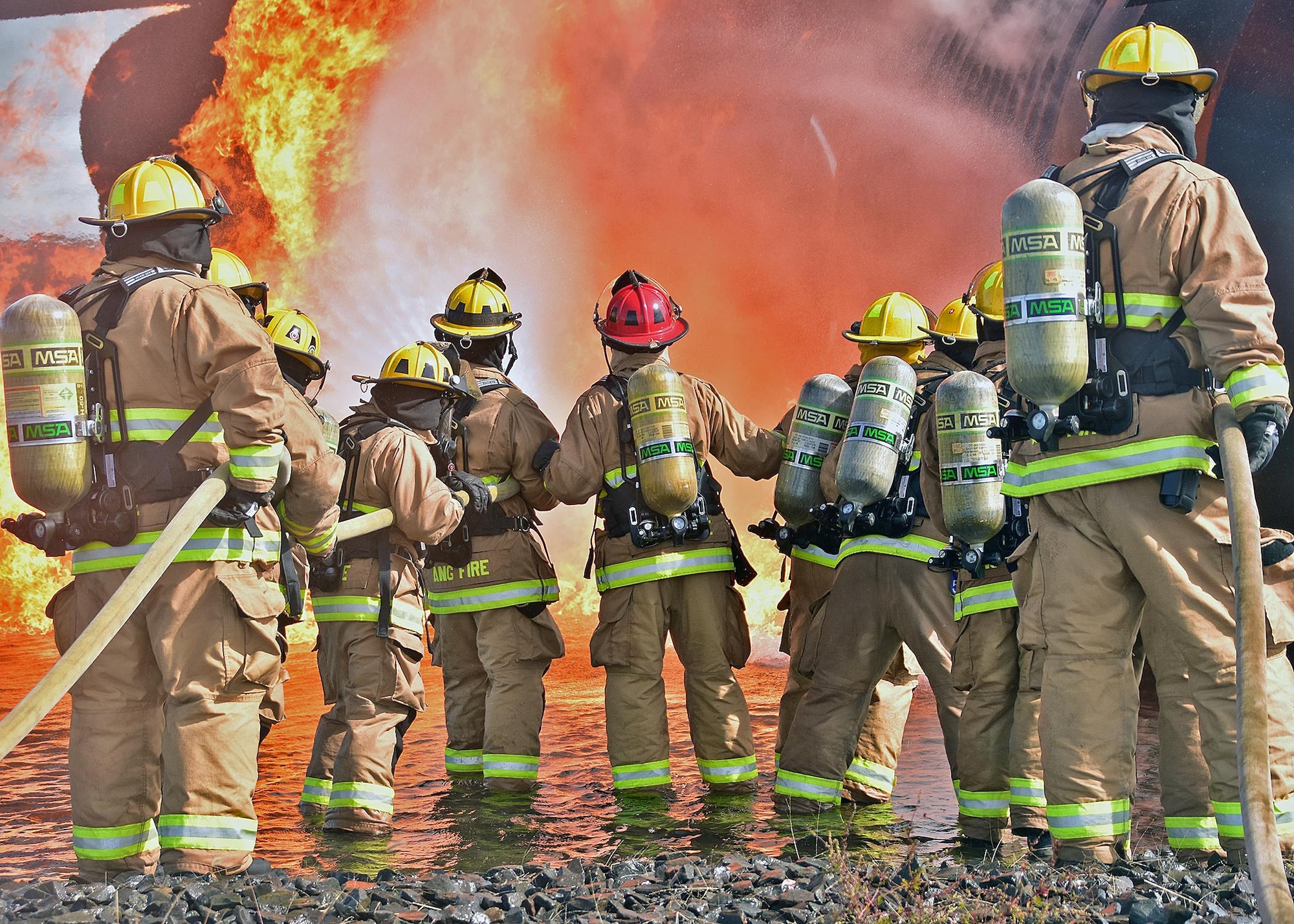 Military and Civilian members of the Quonset Fire Department from the 143d Airlift Wing, Rhode Island Air National Guard conduct live fire training at Westover Air Reserve Base, Chicopee, Massachusetts, September 29, 2016. The live fire training is part of annual qualification requirements and allows military and civilians to train in collaboration. US Air National Guard Photo by Master Sgt Janeen Miller