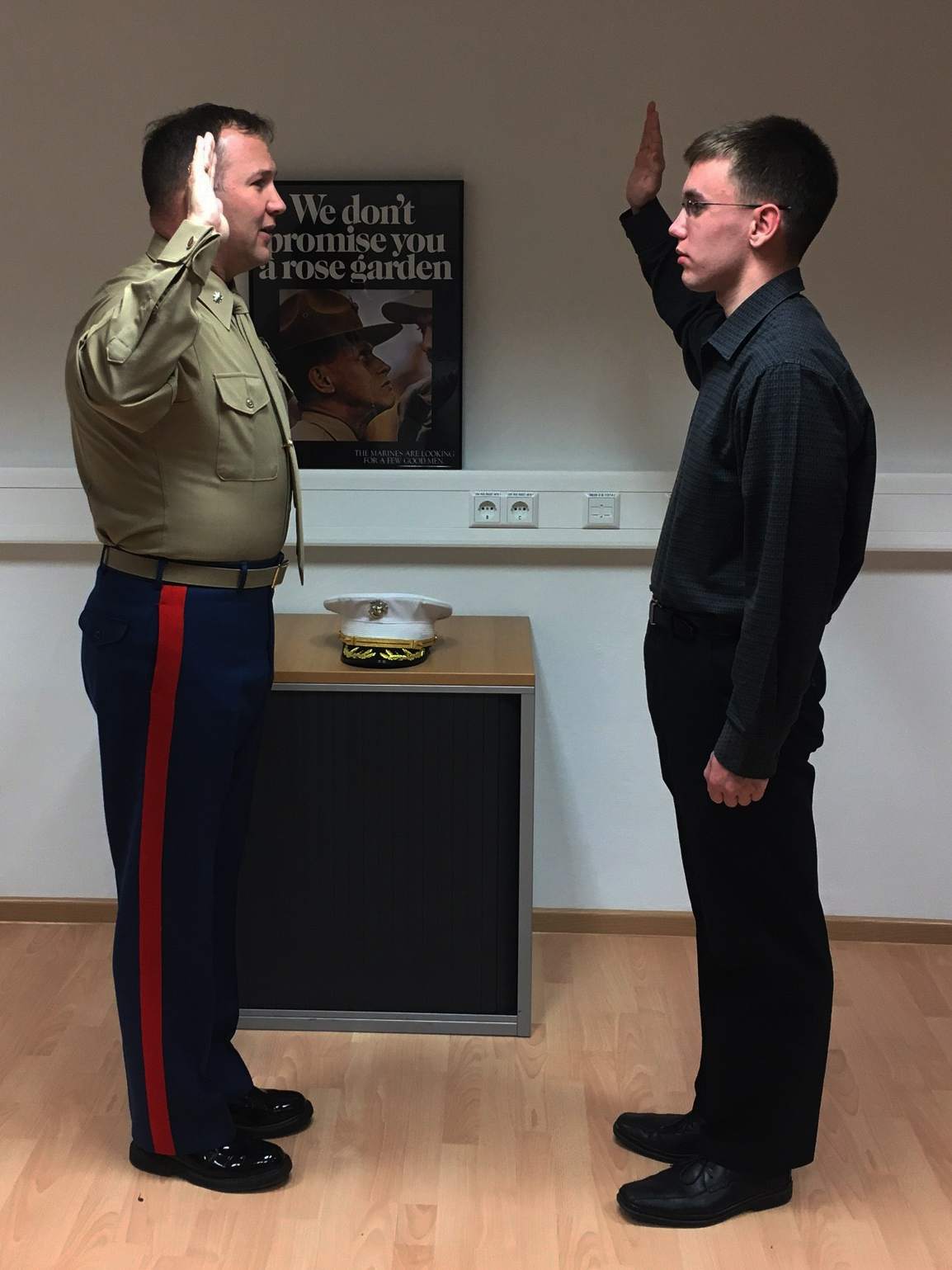 Alex Voyer, senior in Wiesbaden High School, Wiesbaden, Germany, recites the oath of enlistment given by Lt. Col. Gregory Wilson, the officer-in-charge of the Marine liaison team of Landstuhl Regional Medical Center, at the Marine Forces Europe / Africa Headquarters aboard United States Army Garrison Stuttgart, Feb. 8, 2017. Voyer is the first applicant to enlist in the Marine Corps under the delayed entry program since the Marines strted offering enlistment opportunities to DoD Europe personnel in November of 2016.