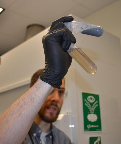 Dr. Zachary Farrell, a research scientist with UES in the Nanoelectronics Branch of the Materials and Manufacturing Directorate, Air Force Research Laboratory, examines liquid metal nanoparticles following ultra-sonication. Researchers here are exploring new potential applications for liquid metals by examining their microscopic properties. (U.S. Air Force photo/ Marisa Alia-Novobilski)


