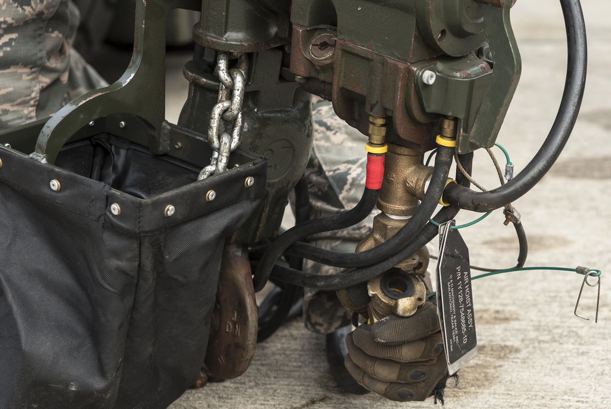 An Airman from the 23d Equipment Maintenance Squadron connects a hose to a Munitions Assembly Conveyer, Feb. 3, 2017, at Moody Air Force Base, Ga. Airmen use the MAC like an assembly line which helps them efficiently construct the munitions that will be used to neutralize threats and protect ground forces. (U.S. Air Force Photo by Airman 1st Class Janiqua P. Robinson)