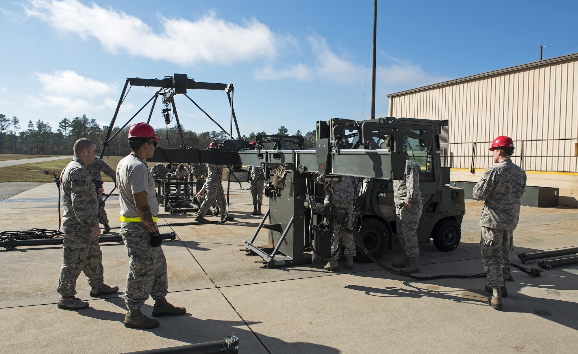 Airmen from the 23d Equipment Maintenance Squadron assemble a Munitions Assembly Conveyer, Feb. 3, 2017, at Moody Air Force Base, Ga. This MAC travels with the Airmen when they deploy, so they must ensure there is no damage, no parts are missing and everything works properly. (U.S. Air Force Photo by Airman 1st Class Janiqua P. Robinson)