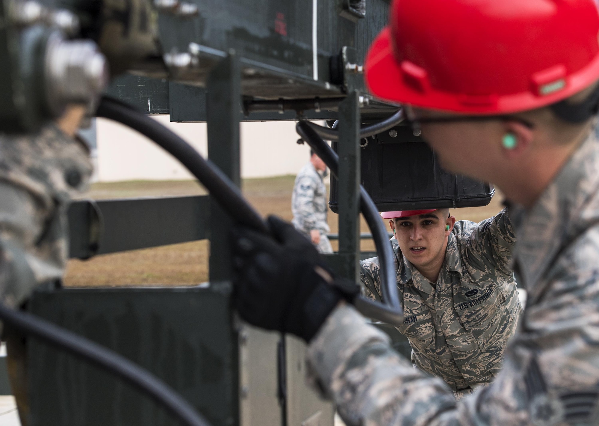 Airmen from the 23d Equipment Maintenance Squadron help put together a Munitions Assembly Conveyer, Feb. 3, 2017, at Moody Air Force Base, Ga. The multi-million dollar system increases efficiency and decreases the amount of time required to assemble munitions. (U.S. Air Force Photo by Airman 1st Class Janiqua P. Robinson)