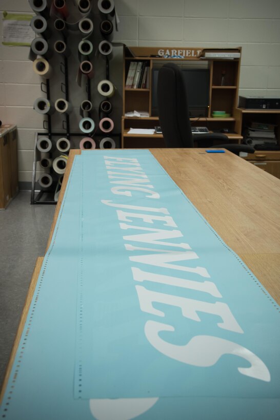 A printed Flying Jennies decal is prepared to be placed on an 815 Airlift Squadron C-130J Super Hercules aircraft by members of the 403rd Wing Fabrication Flight Feb. 1 at Keesler Air Force Base, Mississippi. (U.S. Air Force photo/Staff Sgt. Heather Heiney)